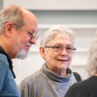 Man and woman smiling at Susan Proctor